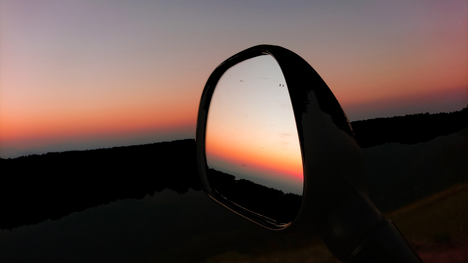 Sunset in the rearview mirror