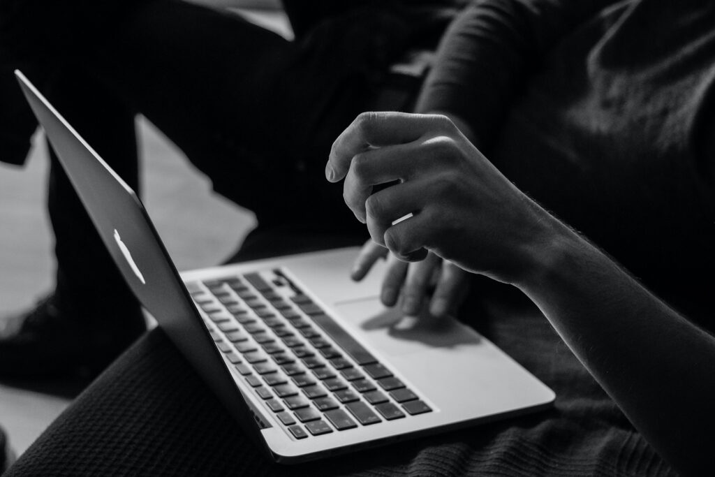 Hands on a laptop, black and white