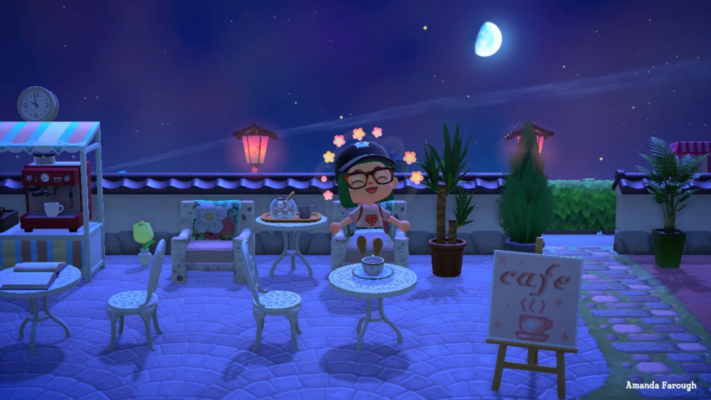 Animal Crossing, one year later. AC avatar in a cafe on her island, with a big smile on her face.